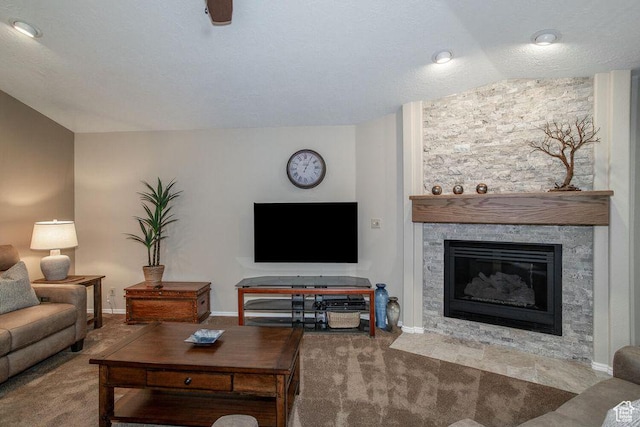 living room with carpet floors, a fireplace, lofted ceiling, and baseboards