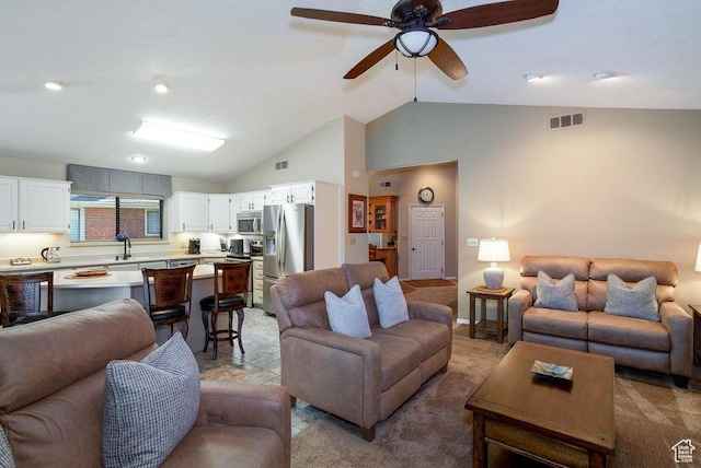 living room featuring vaulted ceiling, light carpet, and a ceiling fan