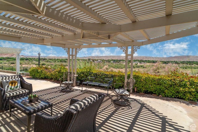 view of patio / terrace with a pergola and a mountain view