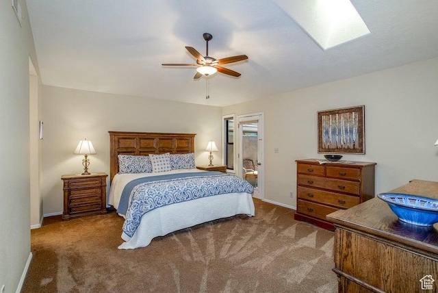 bedroom featuring carpet floors, baseboards, ceiling fan, and a skylight