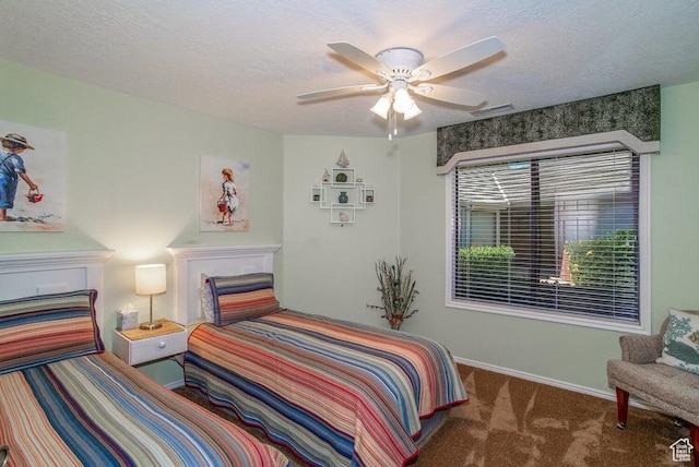 carpeted bedroom with baseboards, ceiling fan, and a textured ceiling