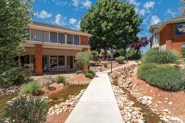 view of yard with a patio and a balcony