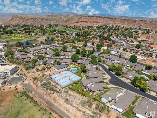 view of property location with a mountain backdrop and nearby suburban area