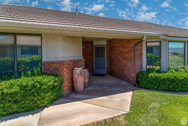 entrance to property featuring brick siding