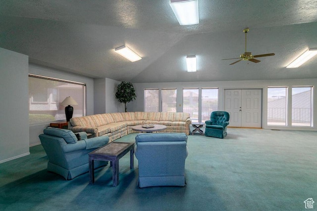 carpeted living room with vaulted ceiling, a textured ceiling, plenty of natural light, and a ceiling fan