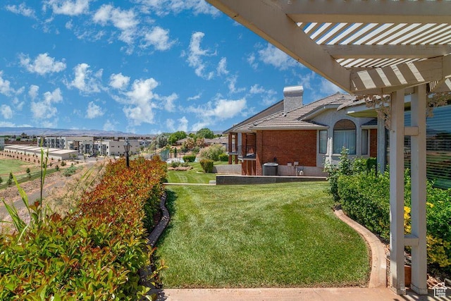 view of grassy yard with a pergola and cooling unit