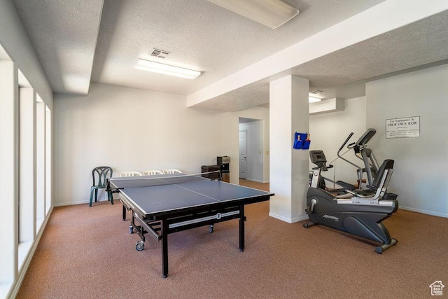 playroom with a textured ceiling, carpet, and baseboards