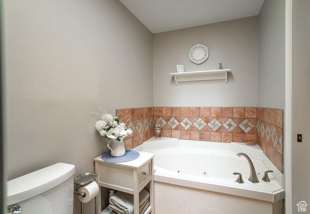 bathroom with toilet and a jetted tub