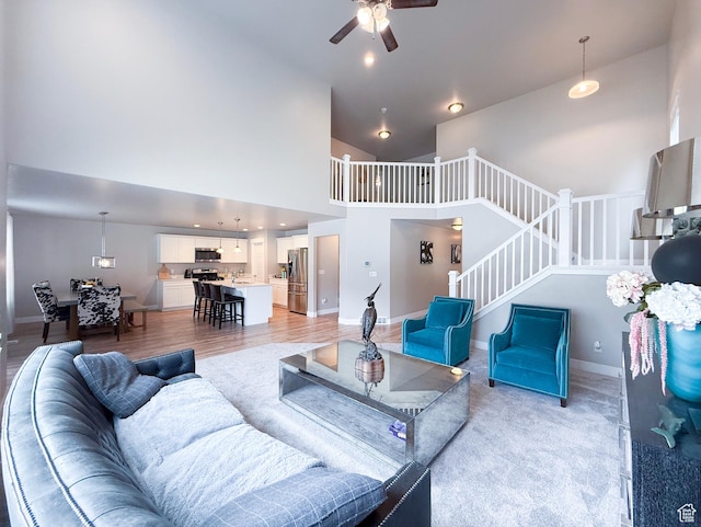 3921 W 1850 N, Lehi, UT 84043 - living area with ceiling fan, stairs, high vaulted ceiling, and baseboards