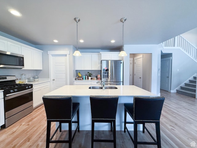 3921 W 1850 N, Lehi, UT 84043 - kitchen with stainless steel appliances, a kitchen bar, light countertops, white cabinets, and recessed lighting