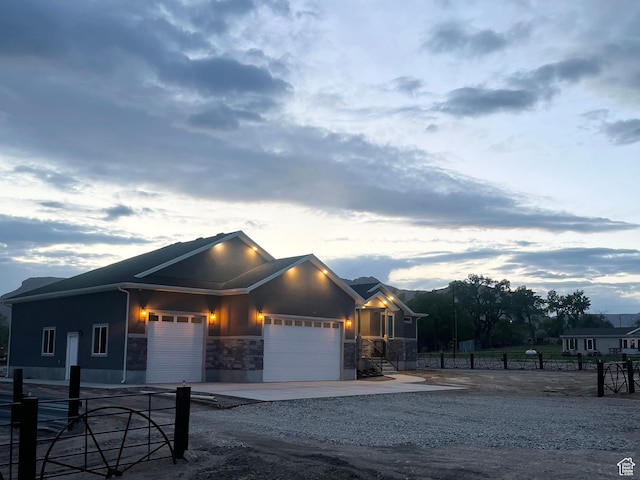 365 N 100 E, Ferron, UT 84523 - view of front of property featuring an attached garage, stone siding, fence, and driveway