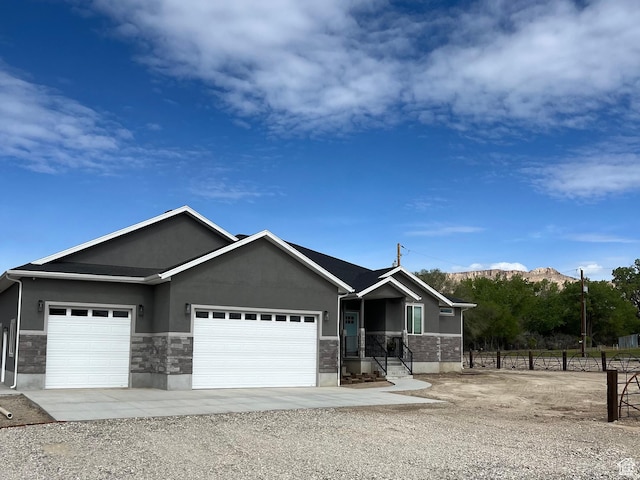 365 N 100 E, Ferron, UT 84523 - ranch-style home with a garage, stucco siding, stone siding, and driveway