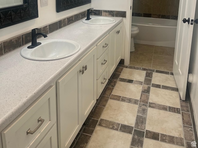 365 N 100 E, Ferron, UT 84523 - bathroom with toilet, double vanity, stone finish floors, and a tub to relax in