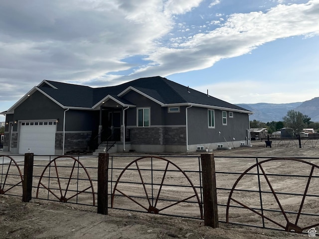 365 N 100 E, Ferron, UT 84523 - ranch-style home featuring a fenced front yard, an attached garage, a mountain view, and stucco siding