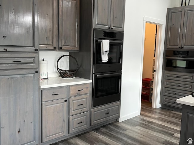 365 N 100 E, Ferron, UT 84523 - kitchen with light countertops, wood finished floors, baseboards, and gray cabinetry