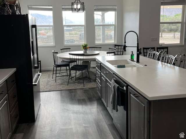 365 N 100 E, Ferron, UT 84523 - kitchen with freestanding refrigerator, a sink, dishwasher, dark wood-style floors, and light countertops
