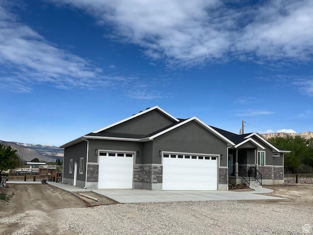 365 N 100 E, Ferron, UT 84523 - ranch-style home featuring a mountain view, stucco siding, and a garage