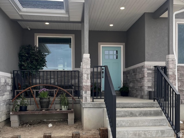 365 N 100 E, Ferron, UT 84523 - doorway to property featuring stucco siding, covered porch, and stone siding