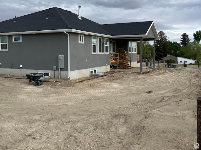 365 N 100 E, Ferron, UT 84523 - rear view of house featuring roof with shingles and stucco siding