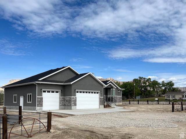 365 N 100 E, Ferron, UT 84523 - view of front of house with a garage, stucco siding, driveway, and fence