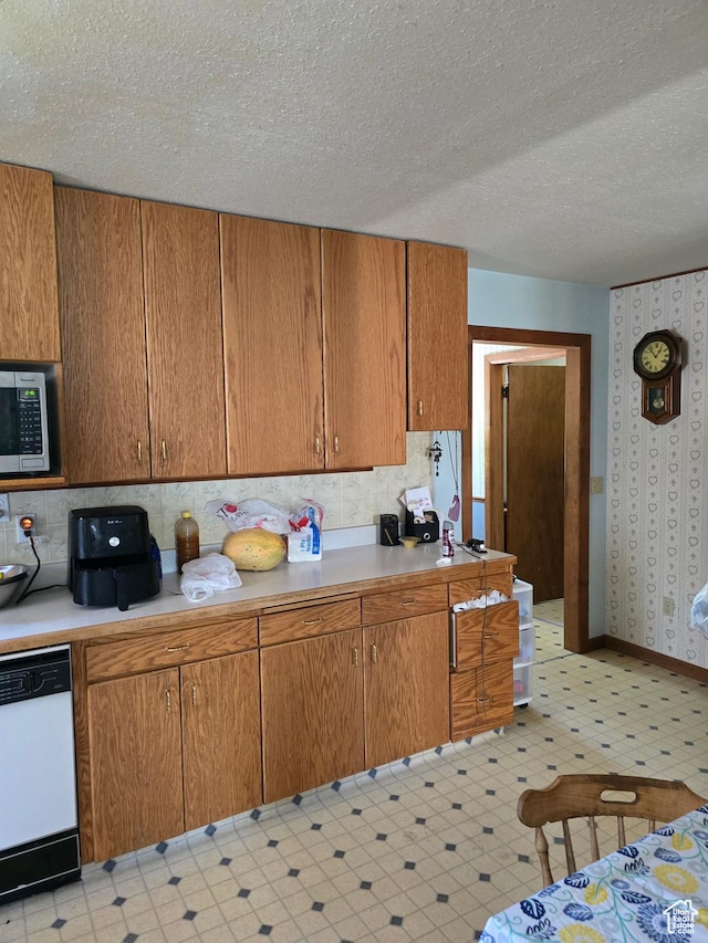 5654 E Cub Rd, Preston, ID 83263 - kitchen with dishwasher, stainless steel microwave, light floors, light countertops, and a textured ceiling