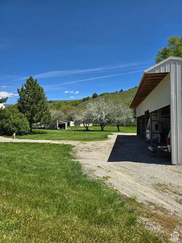 5654 E Cub Rd, Preston, ID 83263 - view of green lawn featuring dirt driveway, an outbuilding, and a pole building