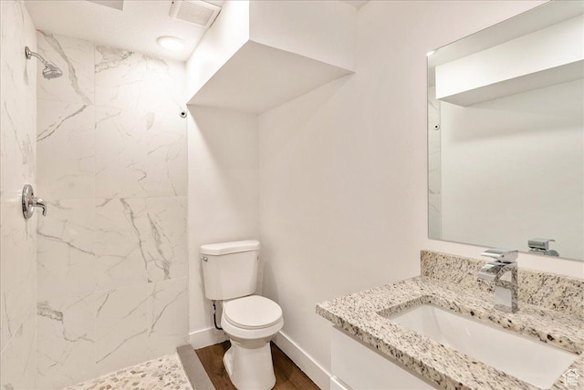 1042 E 460 S, Provo, UT 84606 - bathroom with toilet, a tile shower, wood finished floors, vanity, and baseboards