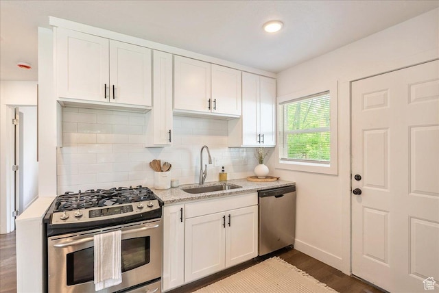1042 E 460 S, Provo, UT 84606 - kitchen featuring appliances with stainless steel finishes, a sink, dark wood-style floors, and decorative backsplash
