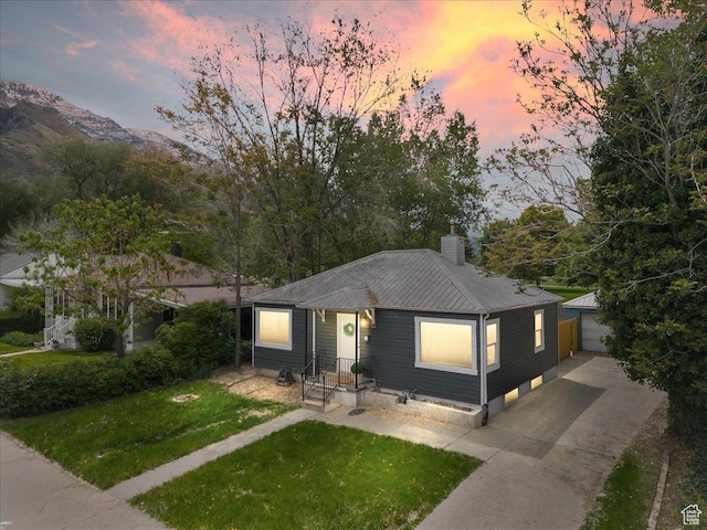 1042 E 460 S, Provo, UT 84606 - view of front facade with metal roof, an outdoor structure, a front yard, and a chimney
