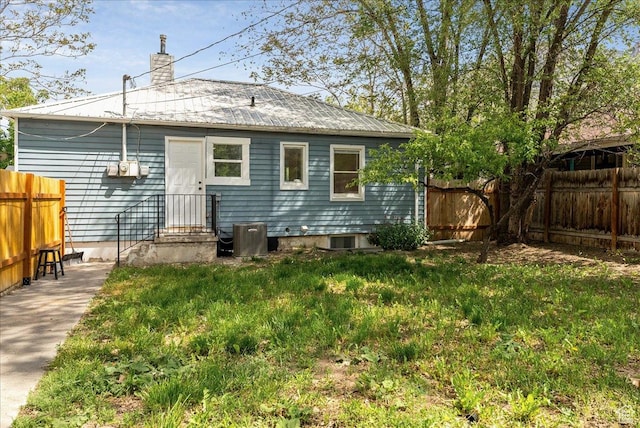 1042 E 460 S, Provo, UT 84606 - rear view of house with a fenced backyard, metal roof, a chimney, and central air condition unit