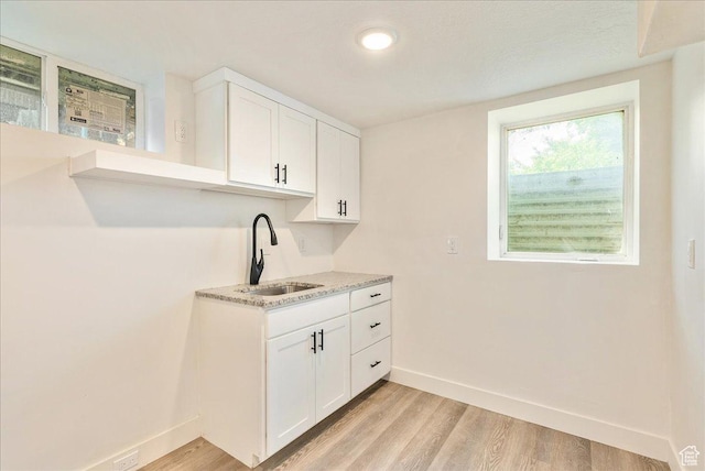 1042 E 460 S, Provo, UT 84606 - kitchen with a sink, baseboards, light wood-type flooring, and light countertops