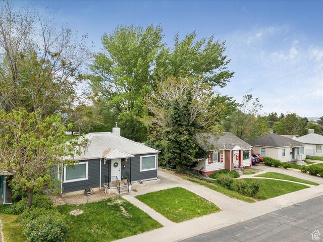 1042 E 460 S, Provo, UT 84606 - view of front of property with driveway, a front yard, and a chimney