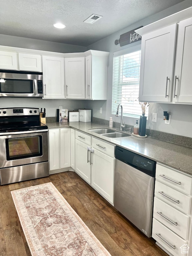 2497 W 500 S Unit 3, Springville, UT 84663 - kitchen with stainless steel appliances, dark wood finished floors, a textured ceiling, a sink, and white cabinetry
