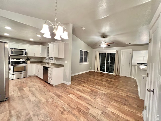 2497 W 500 S Unit 3, Springville, UT 84663 - kitchen featuring stainless steel appliances, a sink, light wood-type flooring, baseboards, and vaulted ceiling