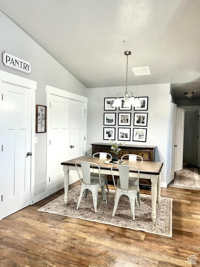 2497 W 500 S Unit 3, Springville, UT 84663 - dining room with a chandelier, wood finished floors, a textured ceiling, lofted ceiling, and baseboards