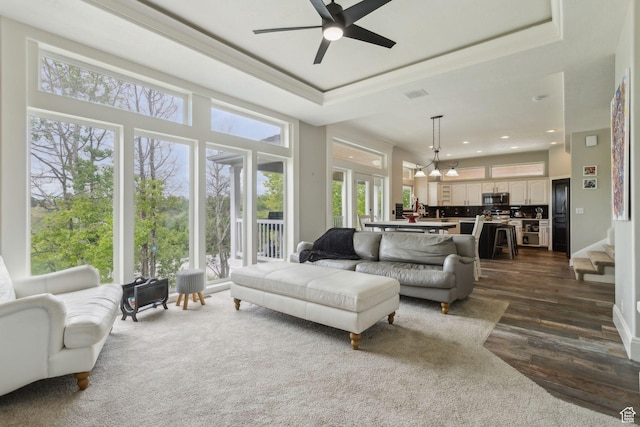 1001 E 1500 N, Layton, UT 84040 - living area featuring crown molding, dark wood-style flooring, a ceiling fan, a raised ceiling, and recessed lighting