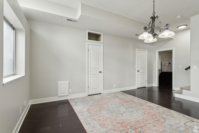 1001 E 1500 N, Layton, UT 84040 - empty room with dark wood-type flooring, a chandelier, baseboards, and stairs