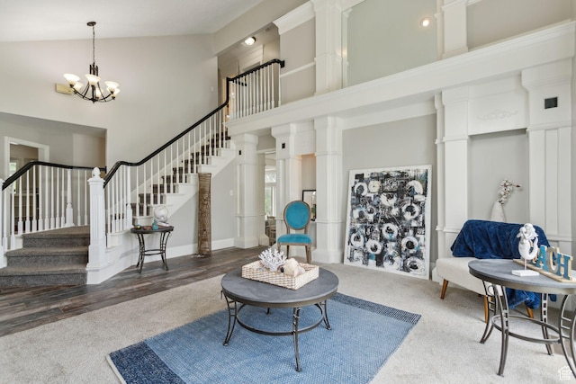 1001 E 1500 N, Layton, UT 84040 - carpeted living room with high vaulted ceiling, a chandelier, stairway, and decorative columns
