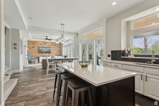 1001 E 1500 N, Layton, UT 84040 - kitchen featuring a sink, a kitchen island, plenty of natural light, dark wood finished floors, and recessed lighting