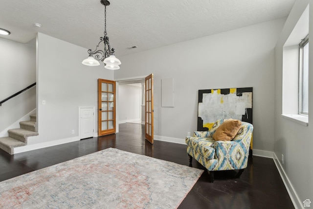 1001 E 1500 N, Layton, UT 84040 - living area featuring french doors, baseboards, dark wood-style floors, and a textured ceiling