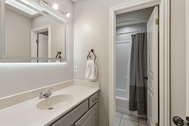 1001 E 1500 N, Layton, UT 84040 - bathroom featuring vanity, tile patterned floors, shower / bath combination with curtain, and a skylight