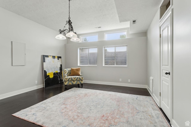 1001 E 1500 N, Layton, UT 84040 - living area with a textured ceiling, a chandelier, dark wood-type flooring, and baseboards