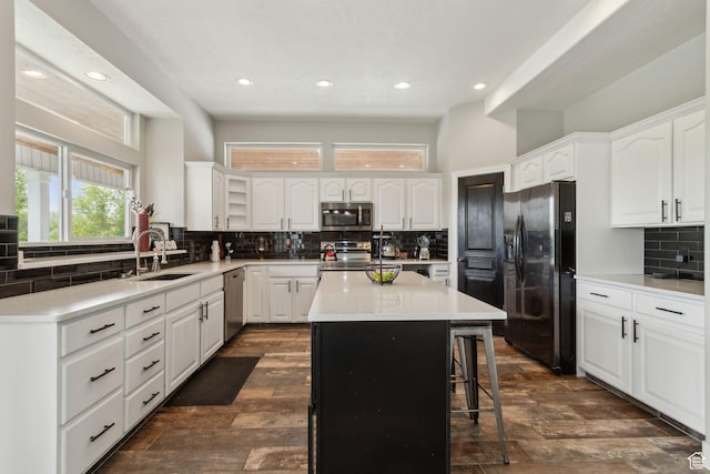 1001 E 1500 N, Layton, UT 84040 - kitchen with appliances with stainless steel finishes, a sink, backsplash, recessed lighting, and a kitchen island