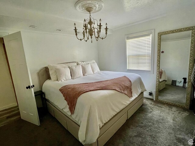 229 N 300 W, Salina, UT 84654 - bedroom featuring crown molding, a chandelier, dark colored carpet, a textured ceiling, and baseboards
