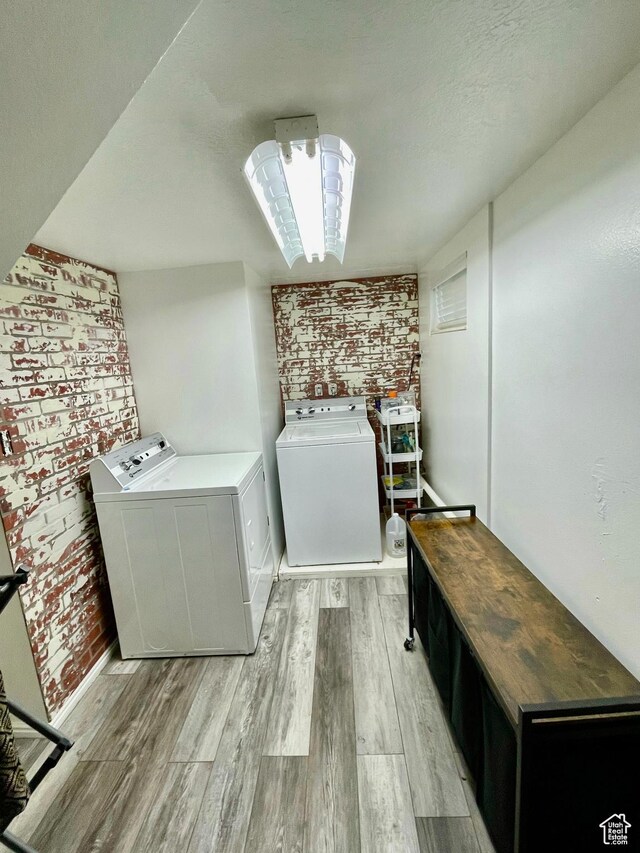 229 N 300 W, Salina, UT 84654 - laundry area featuring washer and dryer, brick wall, and light wood-style flooring