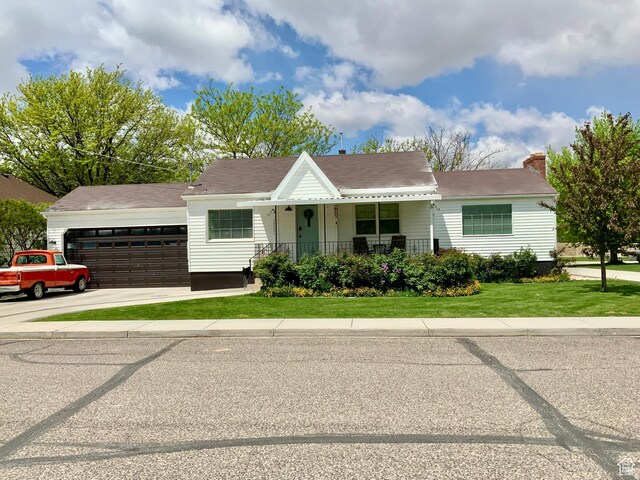 229 N 300 W, Salina, UT 84654 - view of front of home with a front lawn, covered porch, an attached garage, and driveway