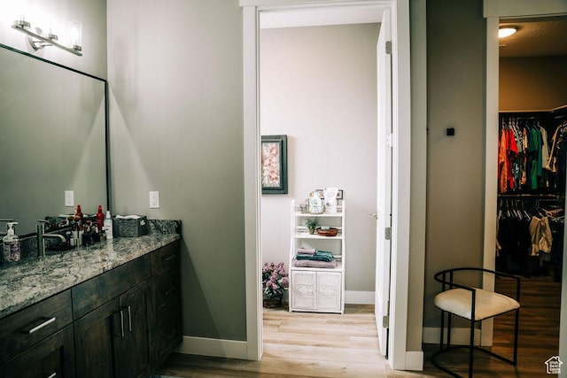 2366 W 3750 N, Cedar City, UT 84721 - bathroom featuring wood finished floors, baseboards, vanity, and a walk in closet