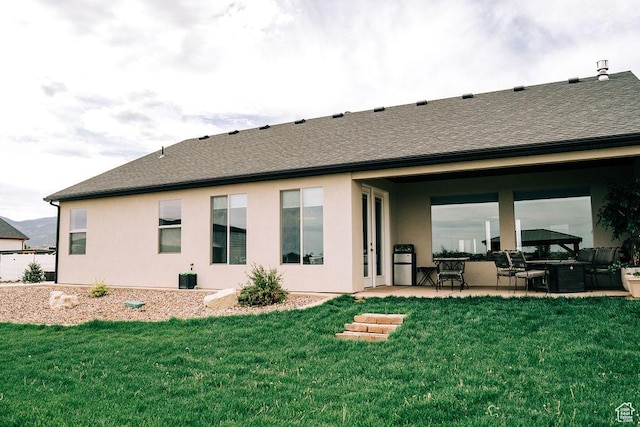2366 W 3750 N, Cedar City, UT 84721 - back of property featuring a patio area, a yard, a shingled roof, and stucco siding
