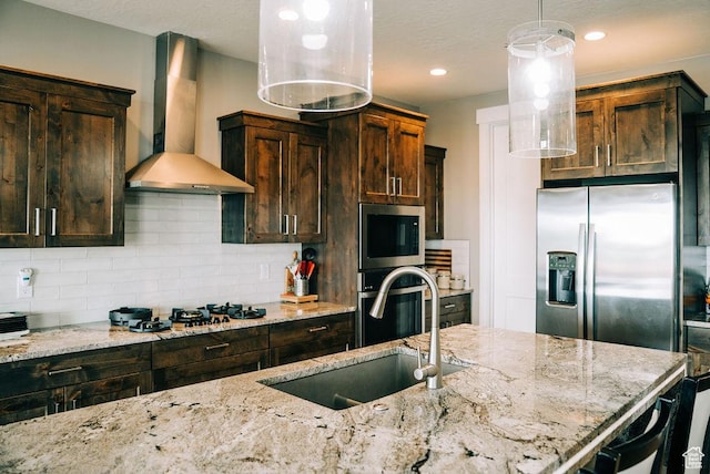 2366 W 3750 N, Cedar City, UT 84721 - kitchen with wall chimney exhaust hood, appliances with stainless steel finishes, a sink, decorative backsplash, and light stone countertops