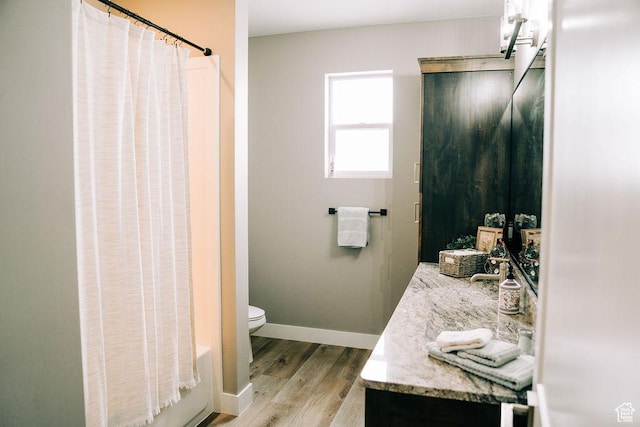 2366 W 3750 N, Cedar City, UT 84721 - full bathroom with wood finished floors, vanity, toilet, baseboards, and shower / bath combination with curtain